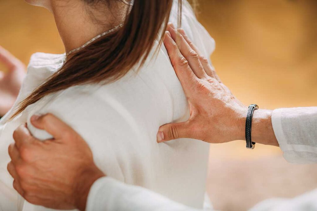 Person consulting with a chiropractor about a treatment plan in a calm clinical office.